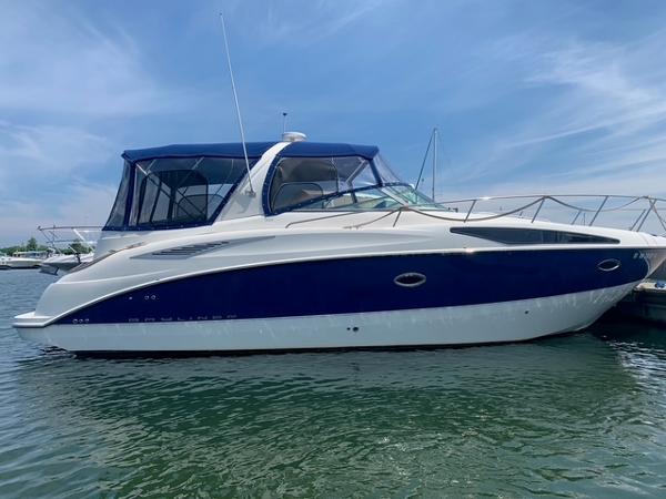Bayliner 325 2007 Bayliner 325 boat docked on calm water under a clear blue sky.