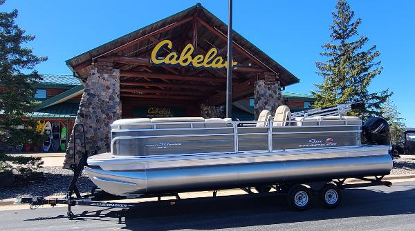Sun Tracker Party Barge 24 DLX 2024 Sun Tracker Party Barge 24 DLX pontoon boat displayed outside Cabela's store.