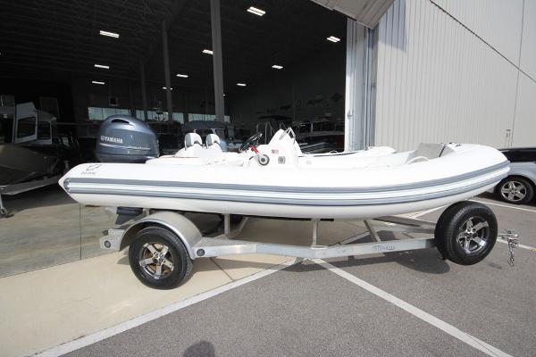 Zodiac Yachtline 490 Deluxe NEO 90hp In Stock 2025 Zodiac Yachtline 490 Deluxe NEO 90hp on trailer, parked outside a showroom.