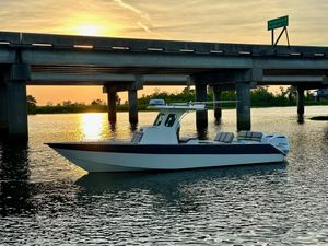 Custom Leblanc CC Custom 2003 Leblanc CC boat on water at sunset near bridge.