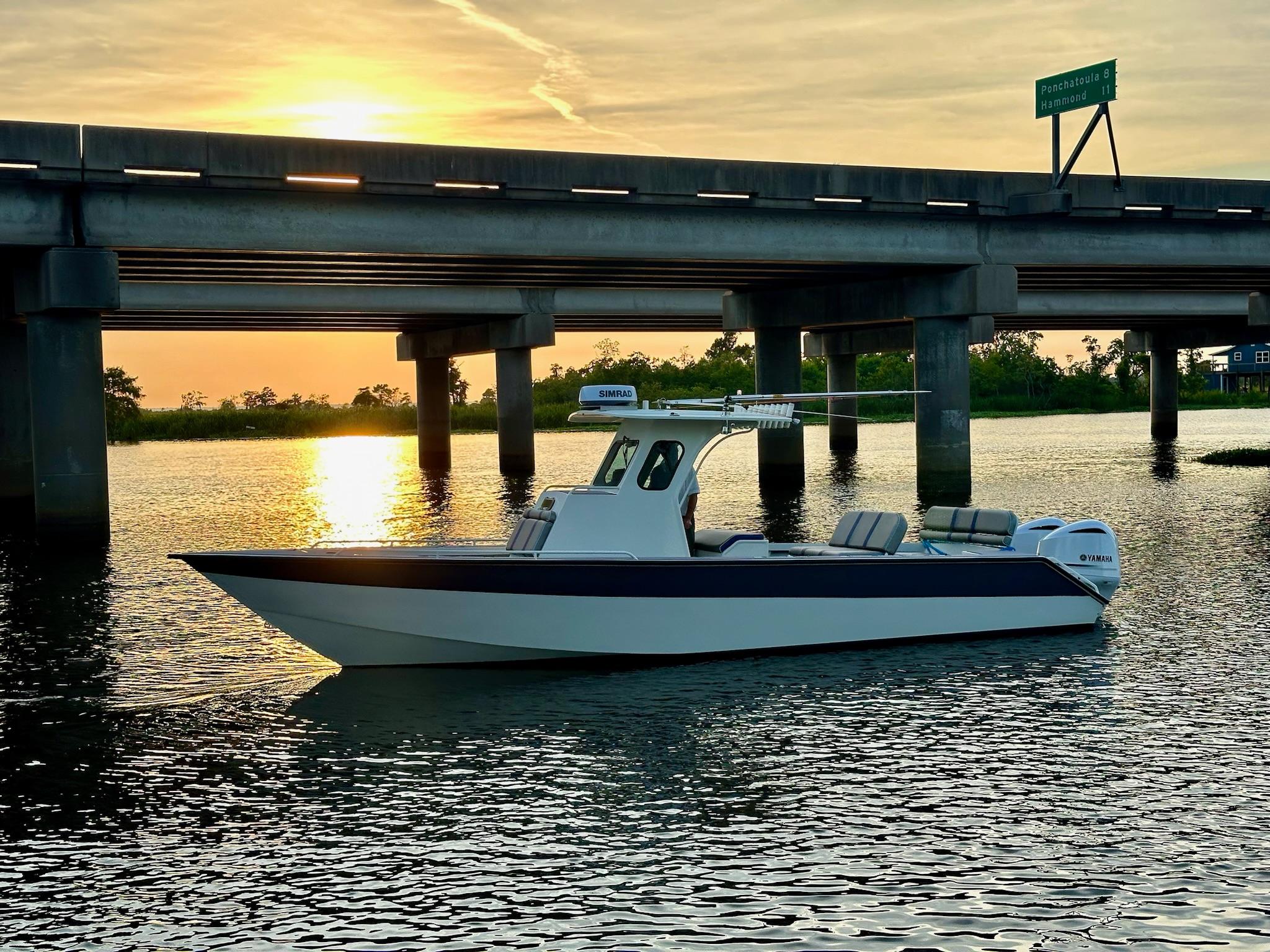 Custom Leblanc CC Custom 2003 Leblanc CC boat on water at sunset near bridge.