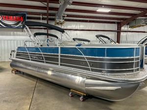 Trifecta 24 UL LE 2025 Trifecta 24 UL LE pontoon boat in showroom, featuring sleek design and modern amenities.