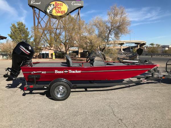 Tracker Bass Tracker Classic XL 2025 Tracker Bass Tracker Classic XL boat in red, parked near Bass Pro Shops.