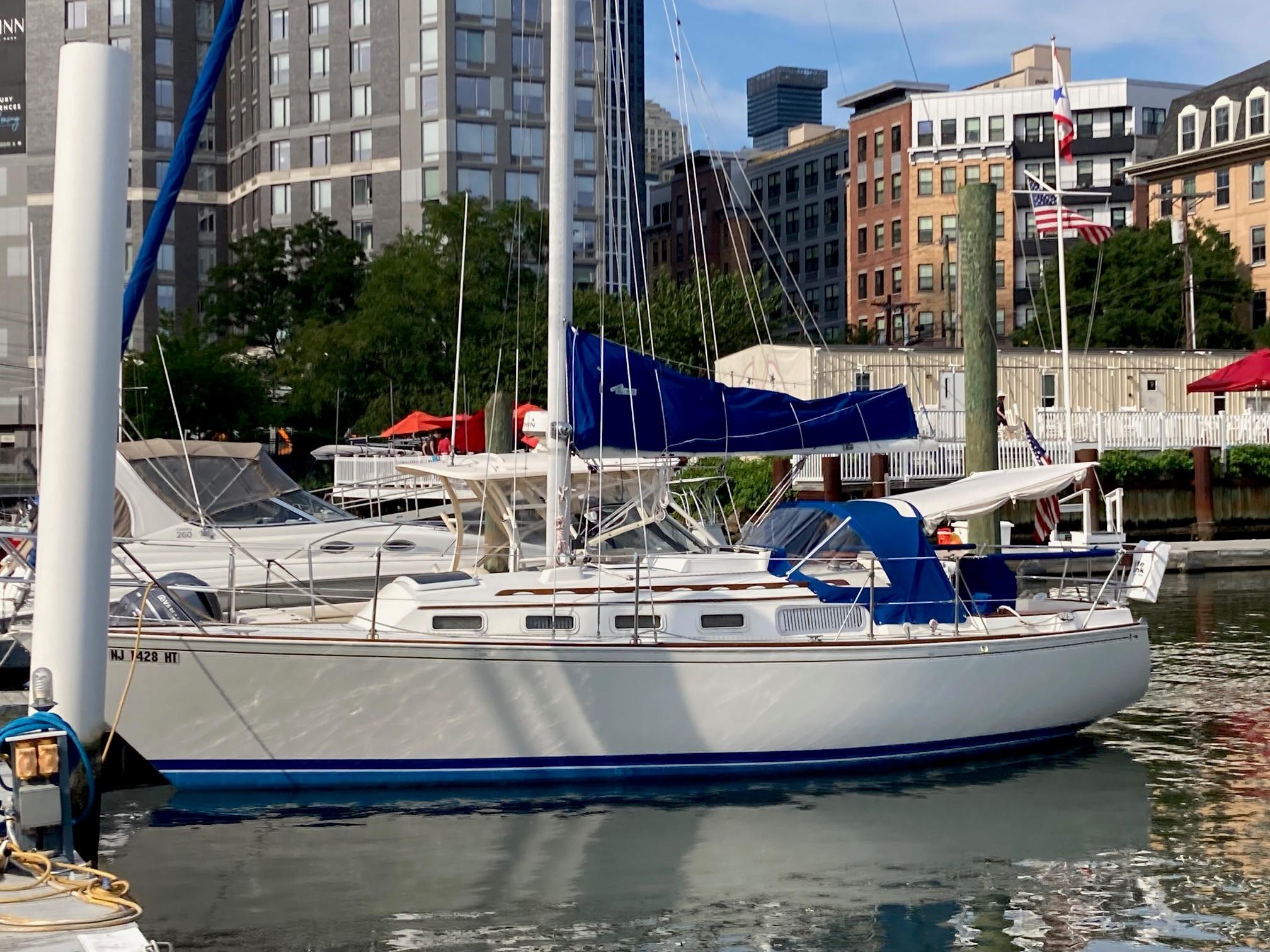 Sabre 30 1982 Sabre 30 sailboat docked in urban marina, surrounded by city buildings.