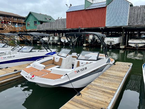 Starcraft SVX 210 IO Wake Tower 2023 Starcraft SVX 210 IO Wake Tower boat docked at a marina.