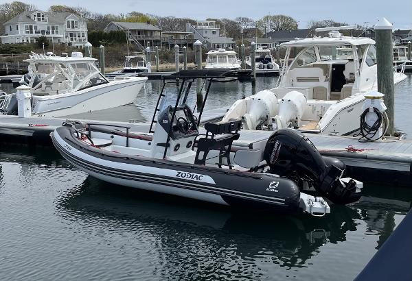 Zodiac Open 6.5 2024 Zodiac Open 6.5 boat docked in a marina with other vessels.