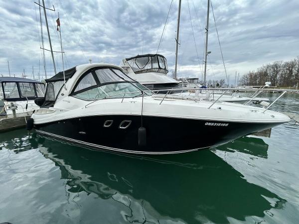 Sea Ray 330 Sundancer 2010 Sea Ray 330 Sundancer yacht docked in a marina under cloudy skies.