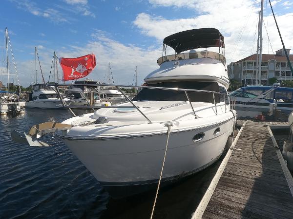Meridian 341 Sedan 2003 Meridian 341 Sedan yacht docked at a marina with a red flag.