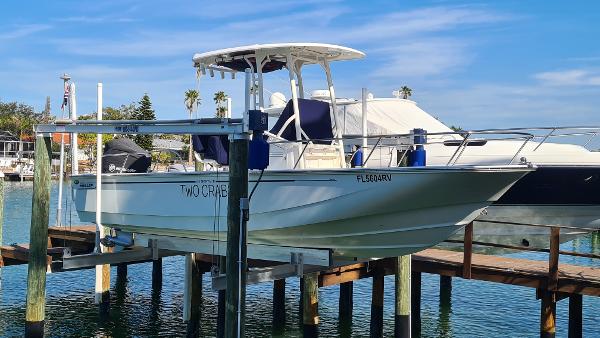 Boston Whaler 210 Montauk 2019 Boston Whaler 210 Montauk boat docked on a lift in a marina.