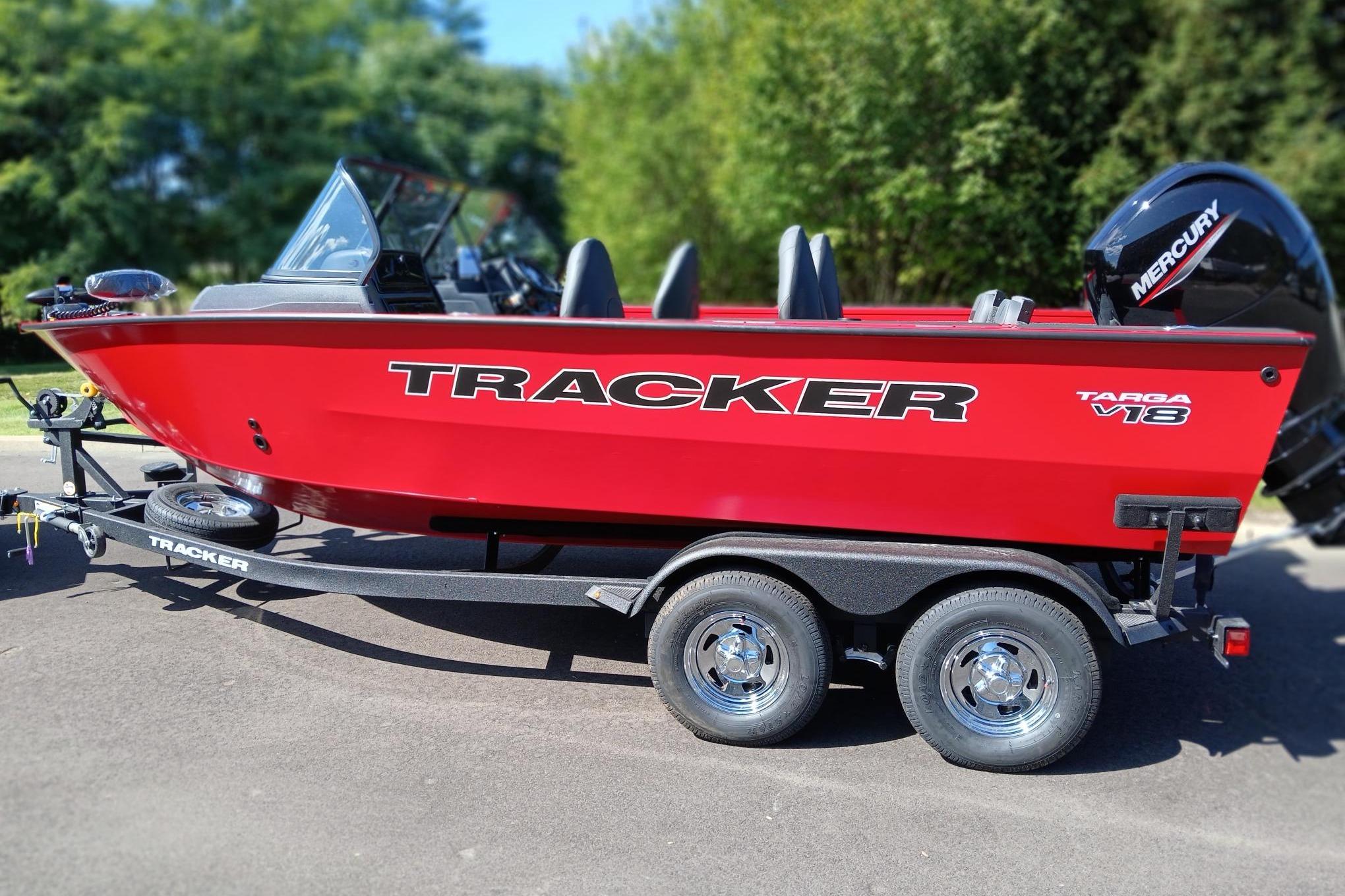 Tracker Targa V-18 Combo 2026 Tracker Targa V-18 Combo boat on trailer, vibrant red, parked outdoors.