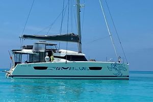 Fountaine Pajot Catamaran Elba 45 2021 Fountaine Pajot Catamaran Elba 45 sailing on clear turquoise waters.