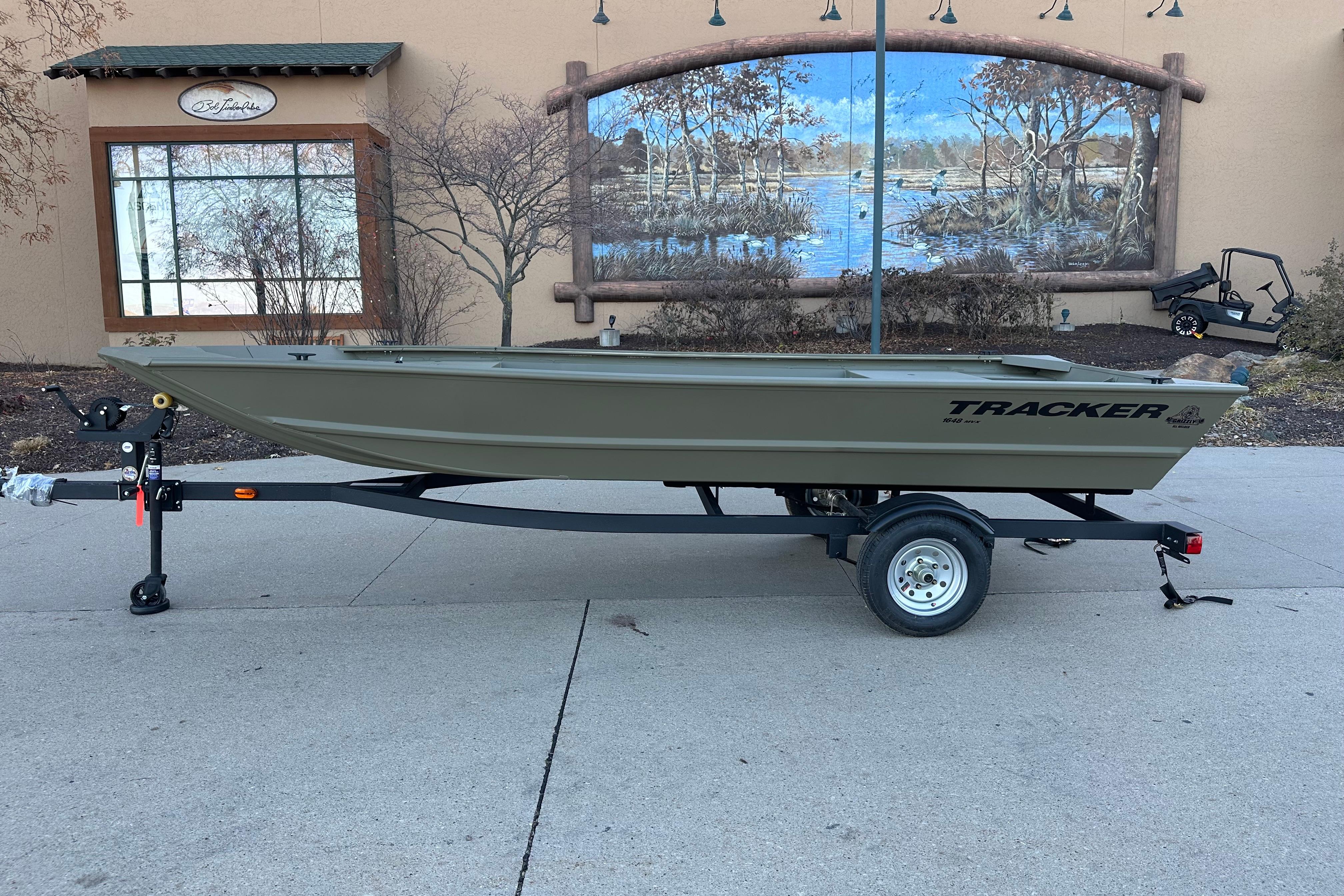 Tracker Grizzly 1648 Utility 2026 Tracker Grizzly 1648 Utility boat on trailer, parked outdoors.
