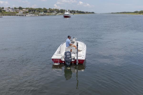 Sea Pro 180 Center Console 2005 Sea Pro 180 Center Console boat on calm waterway, distant shoreline and boat visible.