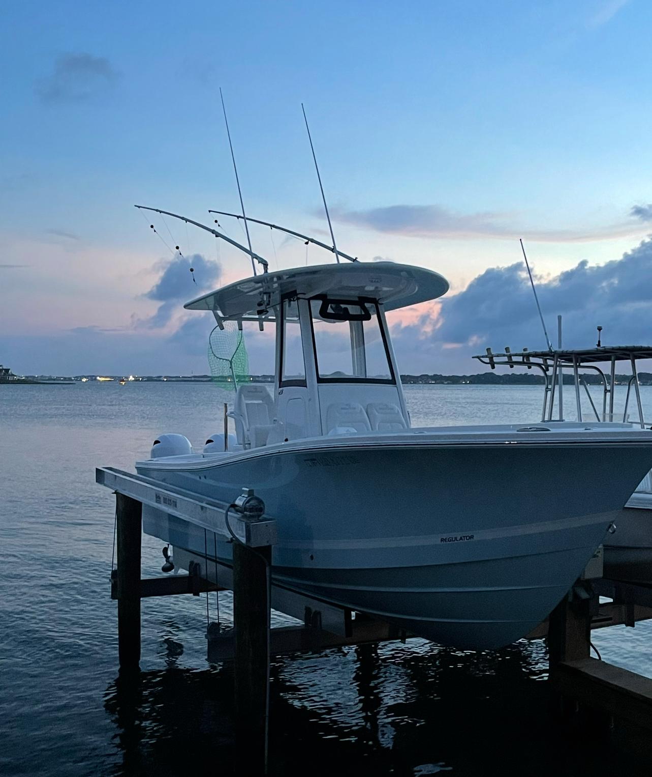 Regulator 23 Cc 2020 Regulator 23'CC boat docked at sunset on calm water.