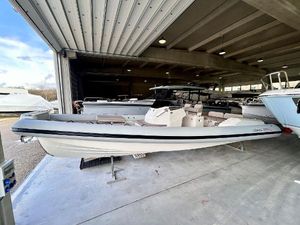 Lomac Turismo 9.5 2025 Lomac Turismo 9.5 boat in a covered storage area, showcasing sleek design.