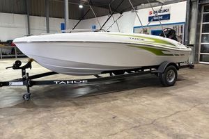 Tahoe T18 2024 Tahoe T18 boat on trailer in showroom, featuring sleek design and green accents.
