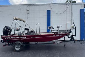 Tracker Pro 170 2022 Tracker Pro 170 boat on trailer, parked against a white and blue wall.