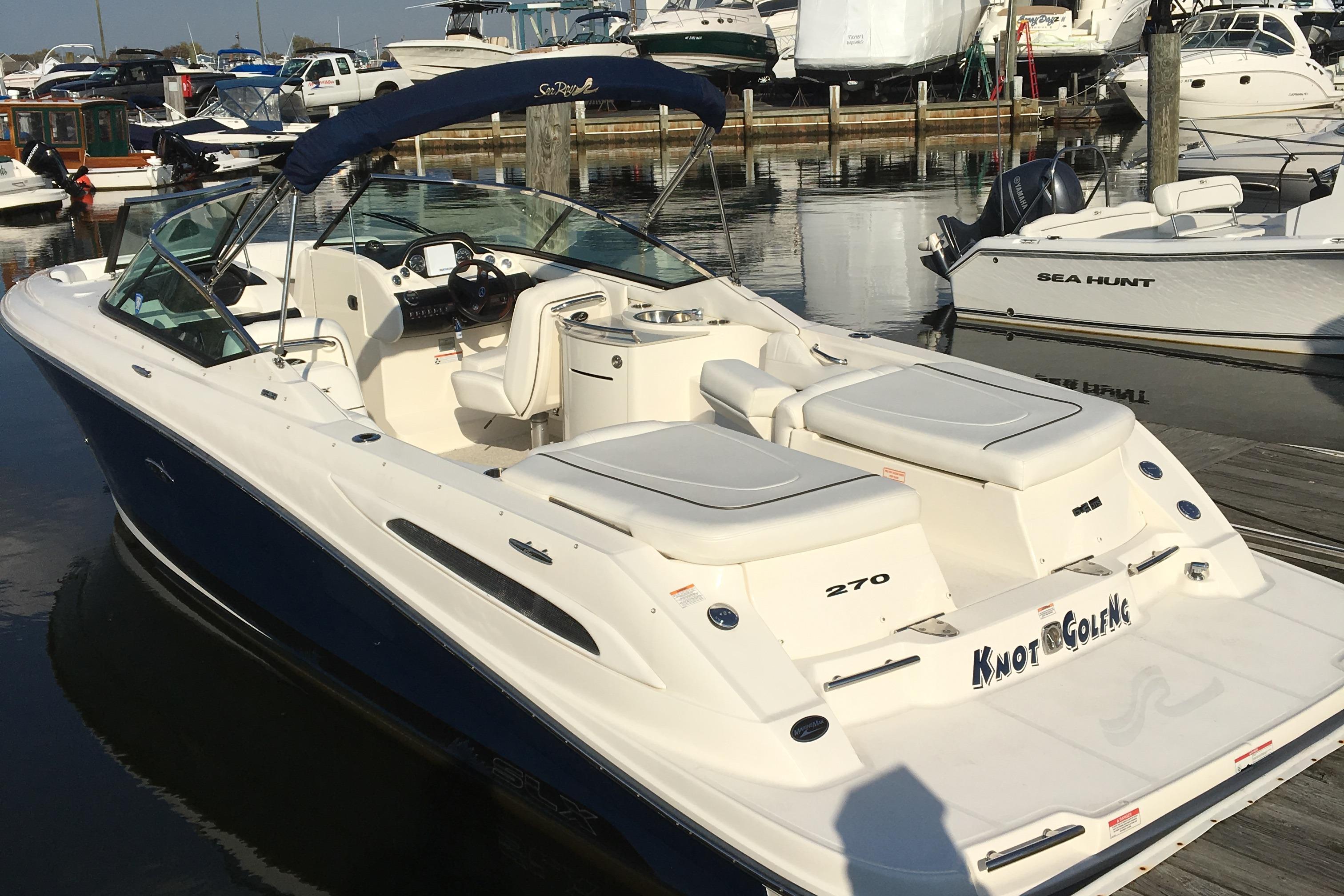Sea Ray 270 SLX 2008 Sea Ray 270 SLX boat docked at marina, featuring spacious seating and sleek design.