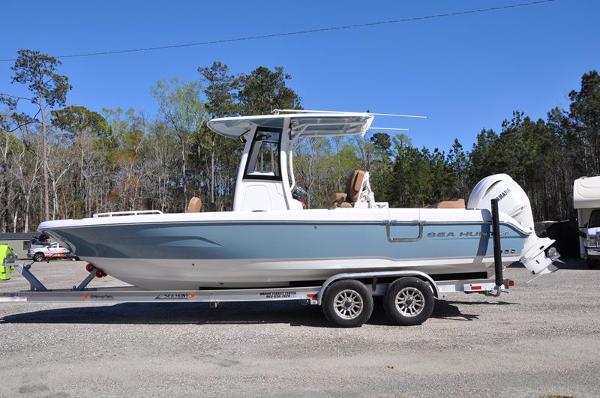 Sea Hunt Escape 25 2023 Sea Hunt Escape 25 boat on trailer, parked outdoors.