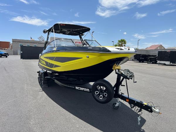 Scarab 255 Wake ID 2023 Scarab 255 Wake ID boat on trailer, vibrant yellow and black design.