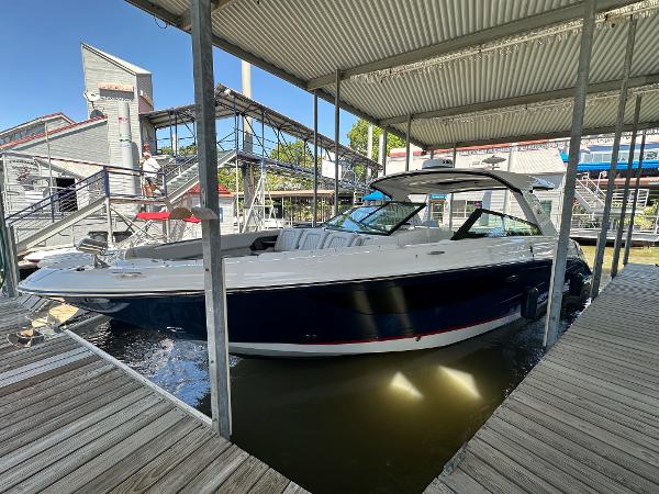 Sea Ray SLX 400 Outboard 2023 Sea Ray SLX 400 OB docked under a covered marina.