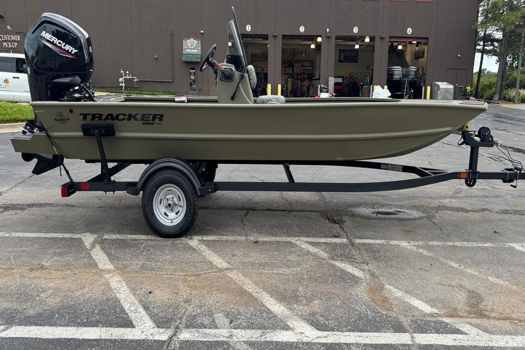 Tracker Grizzly 1860 CC 2026 Tracker Grizzly 1860 CC boat on trailer, parked in a lot.