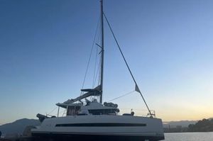 Bali 4.3 2019 Bali 4.3 catamaran docked at sunset with clear sky and mountains.