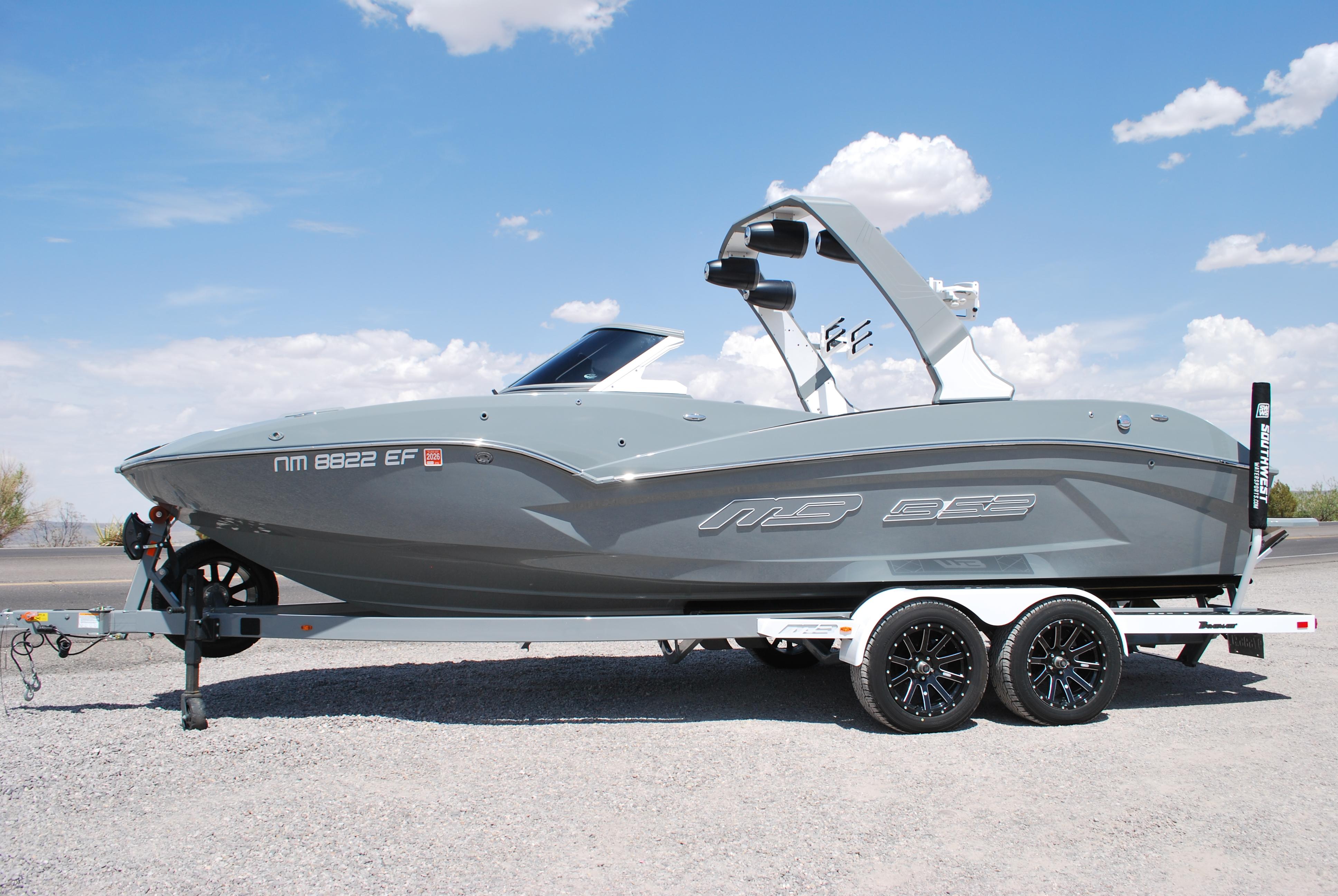 MB 23 Alpha 2023 MB 23 Alpha boat on trailer under clear blue sky.