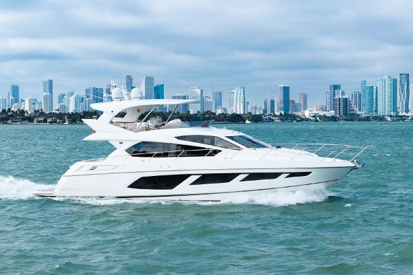 Sunseeker Manhattan 65 2016 Sunseeker Manhattan 65 yacht cruising with city skyline in the background.