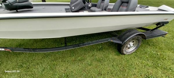 Tracker Pro Team 190 TX 2023 Tracker Pro Team 190 TX boat on trailer, parked on grass.