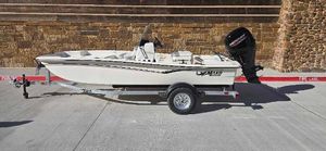 Mako Pro Skiff 15 CC 2025 Mako Pro Skiff 15 CC boat on trailer, parked on concrete surface.