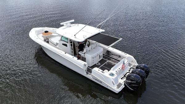 Boston Whaler 370 Outrage 2012 Boston Whaler 370 Outrage boat on calm water, featuring twin outboard engines.