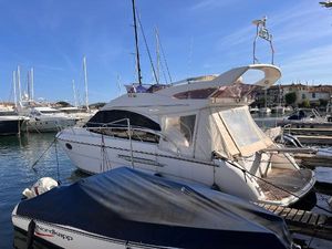Princess 42 Flybridge Motor Yacht 2013 Princess 42 Fly yacht docked in marina under clear blue sky.