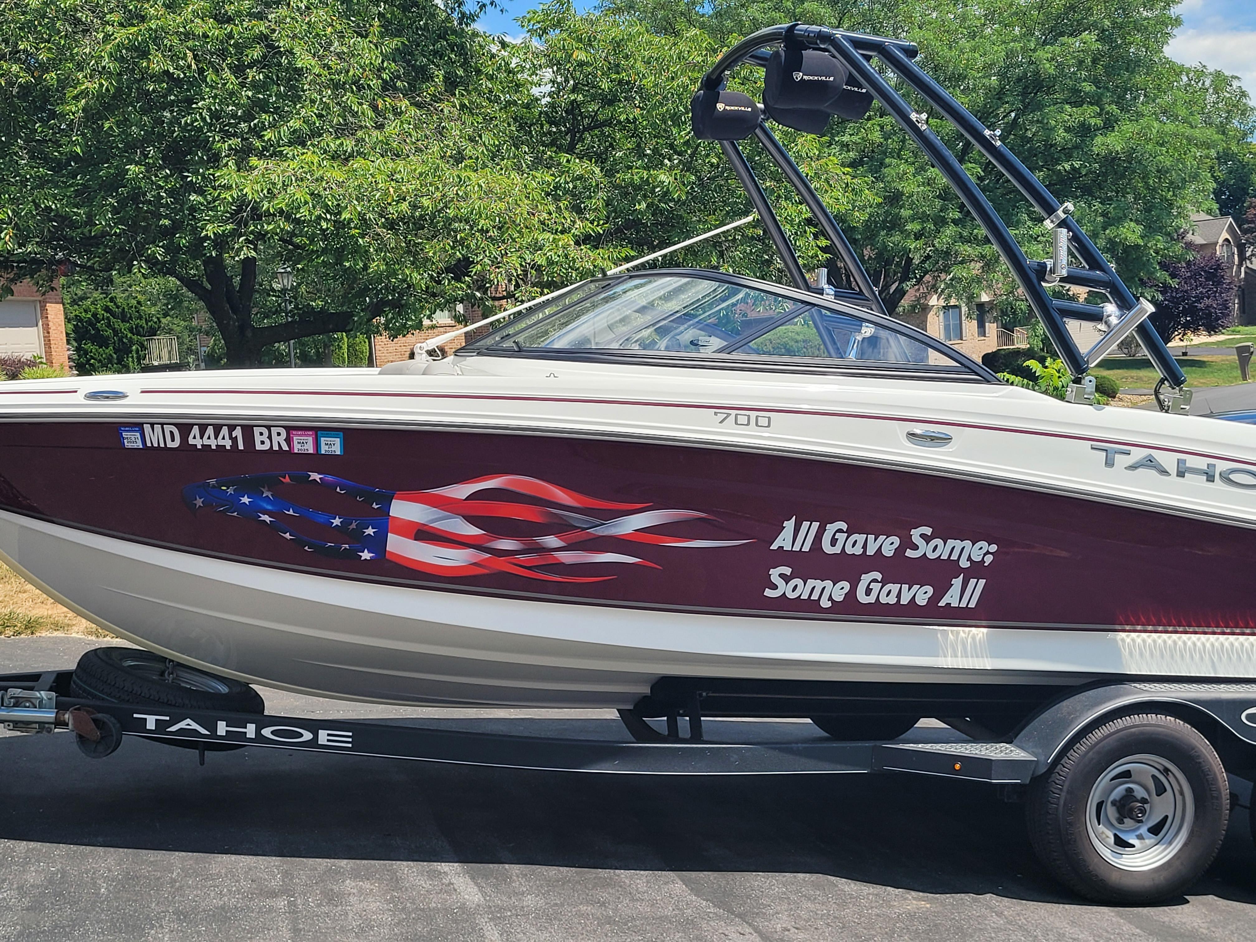 Tahoe 700 2020 Tahoe 700 boat with patriotic graphics and "All Gave Some; Some Gave All" text.