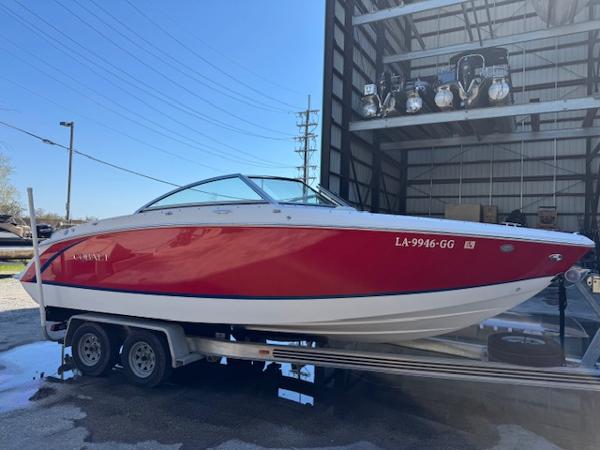 Cobalt R3 2018 Cobalt R3 boat on trailer, red and white, parked near a warehouse.