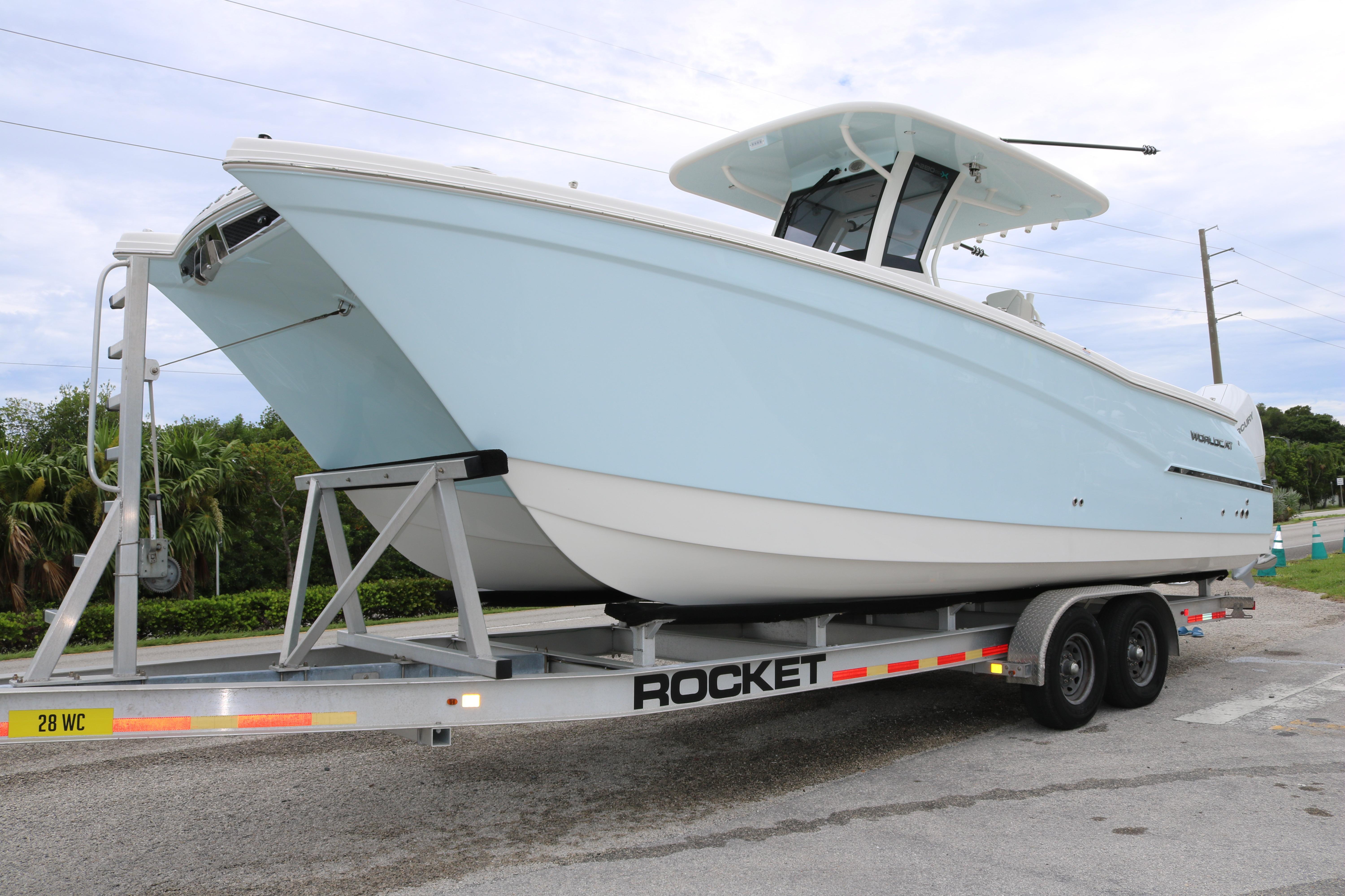 World Cat 280 CC 2025 World Cat 280 CC boat on trailer, light blue hull, parked outdoors.