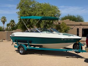 Mariah Talari 182 1995 Mariah Talari 182 boat on trailer with teal canopy, parked outdoors.