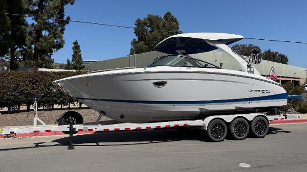 Regal LS9 Surf 2025 Regal LS9 Surf boat on a trailer, parked outdoors.