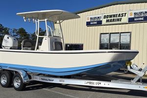Sundance DX22 2026 Sundance DX22 boat on trailer at Downeast Marine dealership.