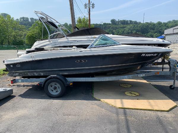 Sea Ray 175 Sport 2006 Sea Ray 175 Sport boat on trailer, parked outdoors, sunny day.