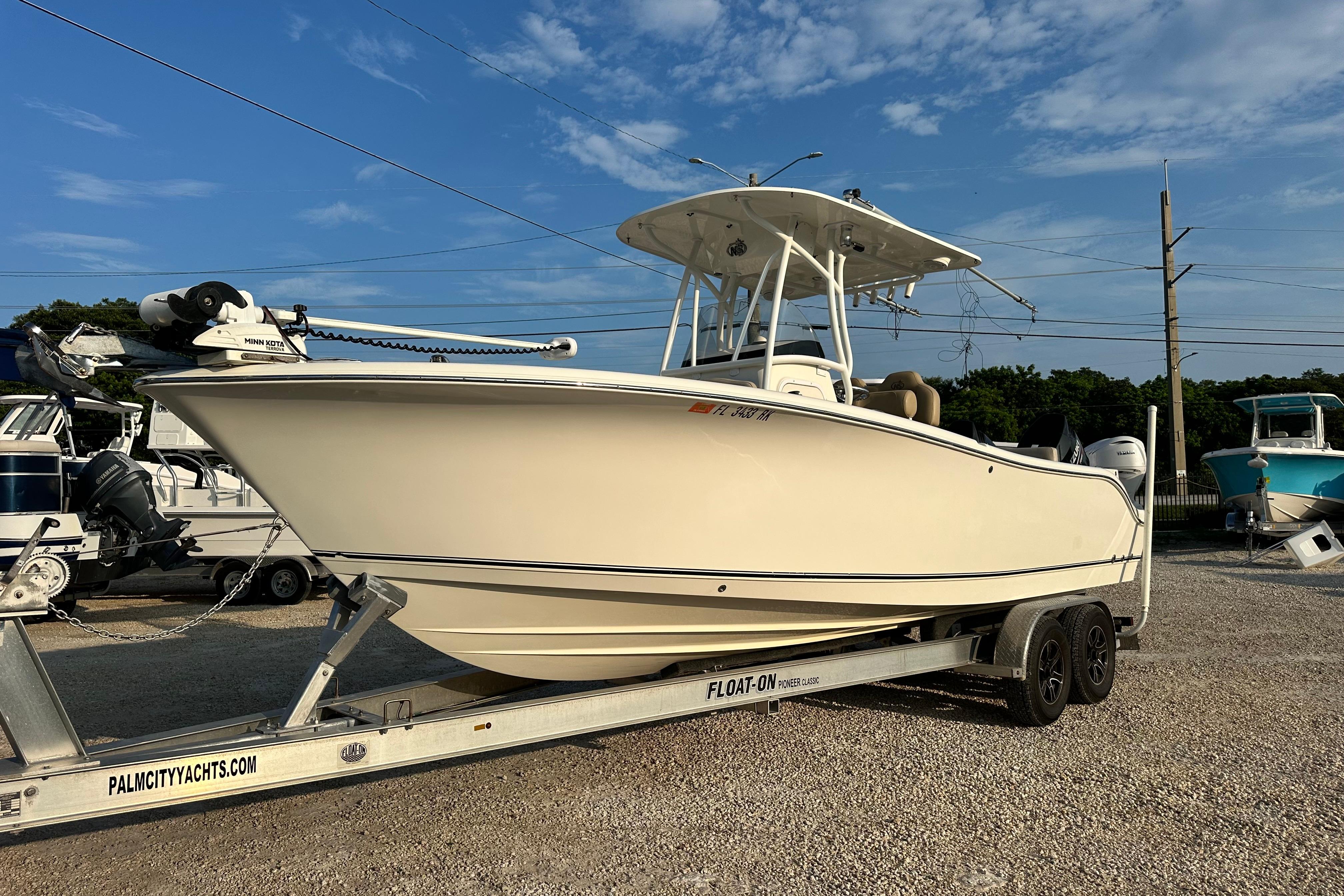 NauticStar 25 XS Offshore 2016 NauticStar 25 XS Offshore boat on trailer under clear blue sky.