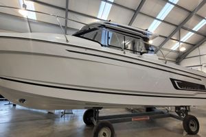Jeanneau Merry Fisher 795 Serie 2 2026 Jeanneau Merry Fisher 795 s2 boat in a showroom on a trailer.