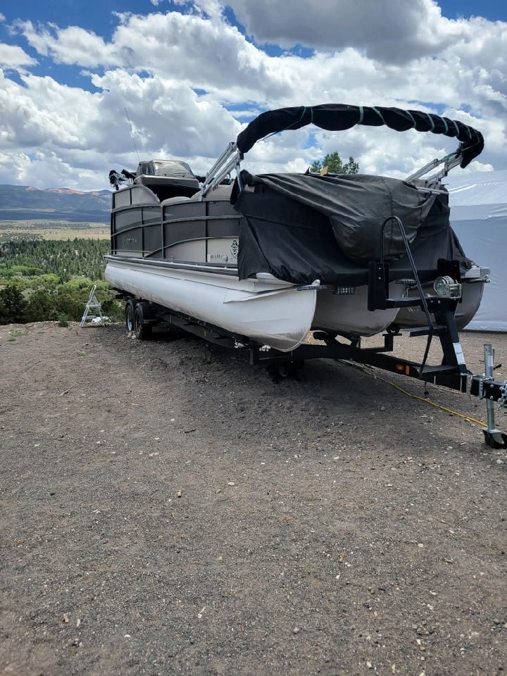 Premier 260 Grand View 2014 Premier 260 Grand View pontoon boat on trailer, scenic mountain backdrop.