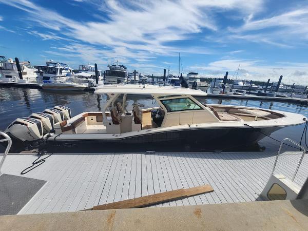 Scout LXF 2021 Scout LXF boat docked at marina under blue sky.