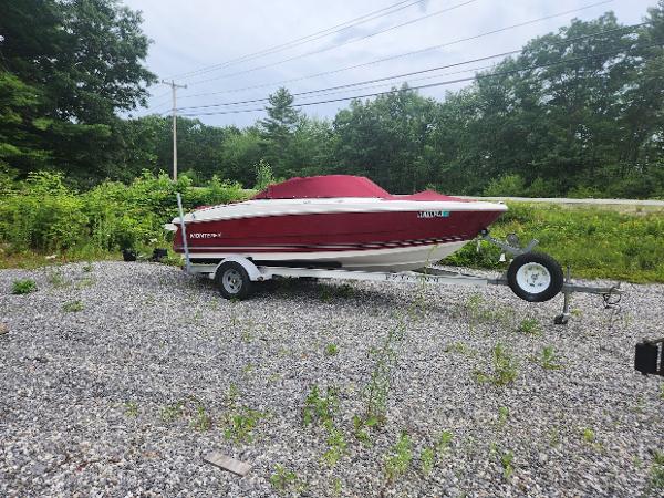 Monterey 180 FS 2007 Monterey 180 FS boat with red cover on a trailer in a gravel lot.