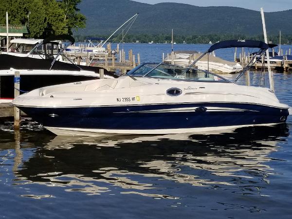 Sea Ray 240 Sundeck 2008 Sea Ray 240 Sundeck boat docked on a serene lake with mountains in the background.