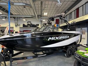 Moomba Craz 2023 Moomba Craz boat in showroom, black and white design, on trailer.