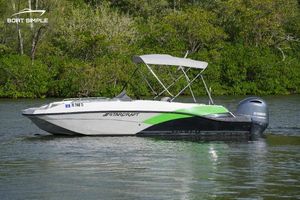Starcraft SVX 191 OB 2023 Starcraft SVX 191 OB boat on a calm lake with lush greenery.