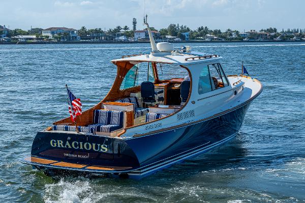 Hinckley Picnic Boat 37 MKIII 2018 Hinckley Picnic Boat 37 MKIII cruising on water, rear view with American flag.