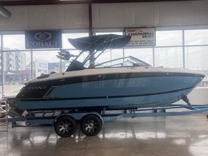 Cobalt R6 Surf 2025 Cobalt R6 Surf boat on trailer in showroom, side view.